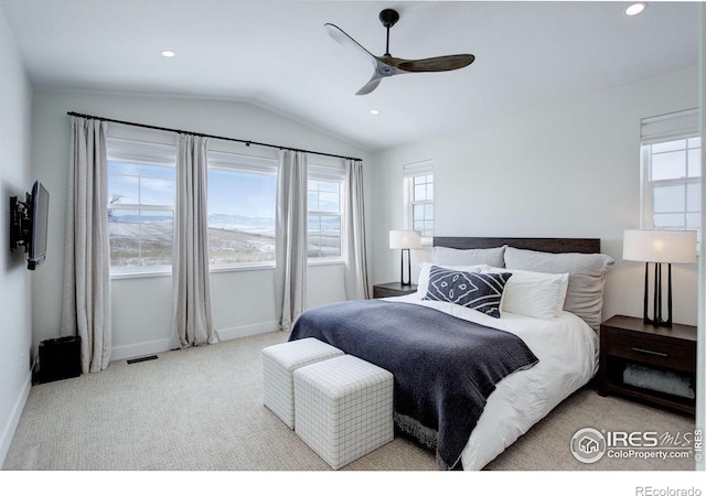 carpeted bedroom with vaulted ceiling and ceiling fan