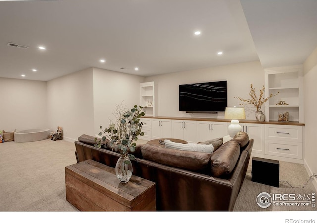 living room with light carpet and built in shelves