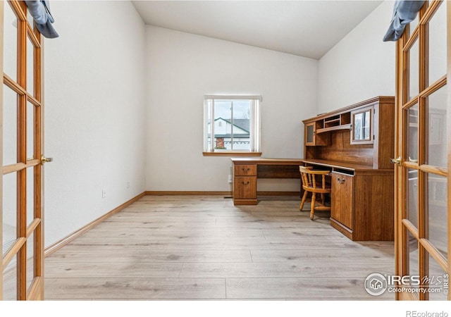 unfurnished office with light wood-type flooring, french doors, and vaulted ceiling