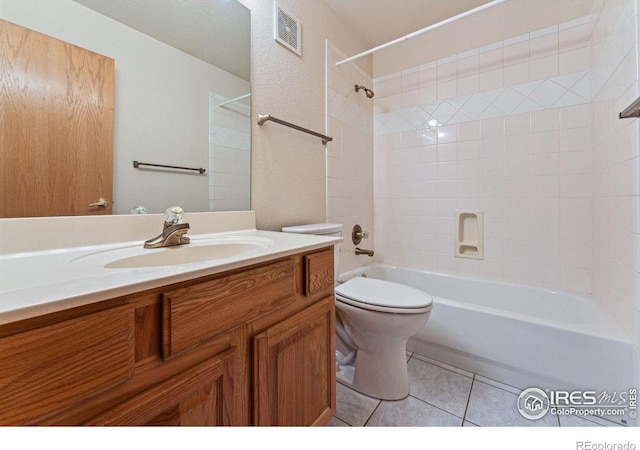 full bathroom featuring tile patterned floors, toilet, vanity, and tiled shower / bath