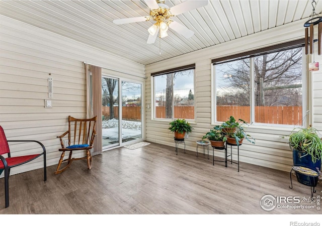 sunroom / solarium with a wealth of natural light, ceiling fan, and wooden ceiling