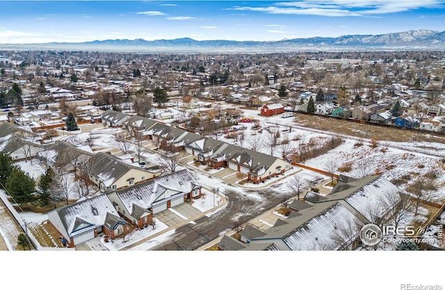 snowy aerial view featuring a mountain view