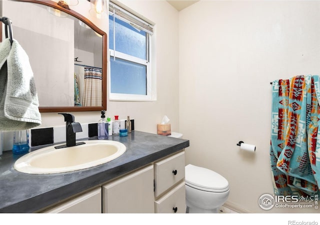 bathroom with toilet and vanity