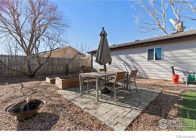 view of patio with a fire pit