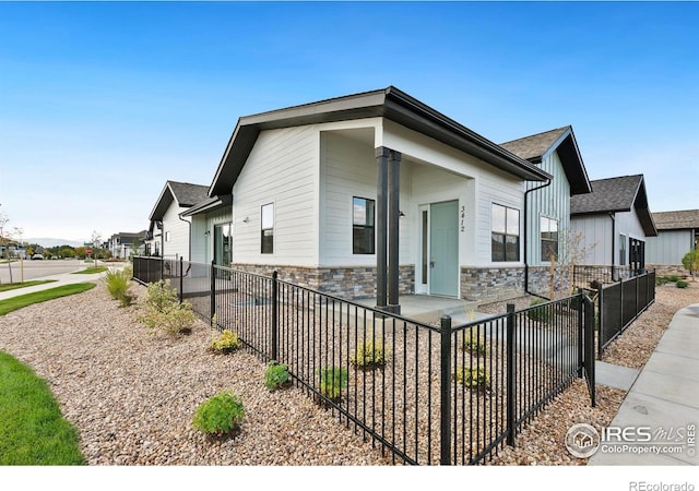 3425 Green Lake Dr, Fort Collins, CO 80524 - exterior space with a fenced front yard and stone siding