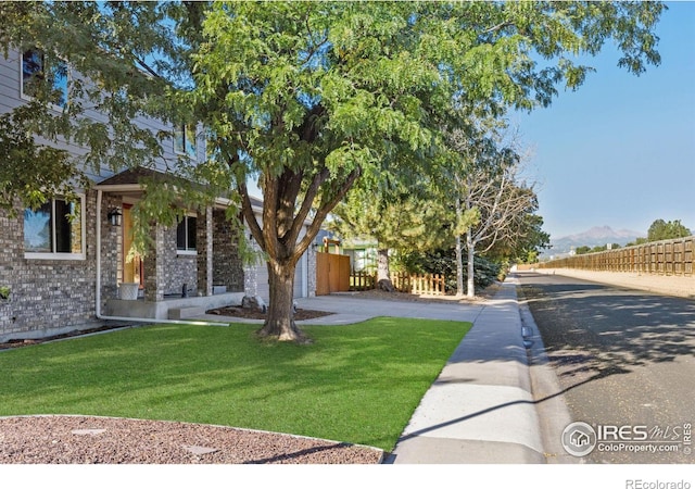 obstructed view of property featuring a front lawn