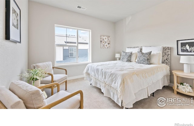 carpeted bedroom with visible vents and baseboards