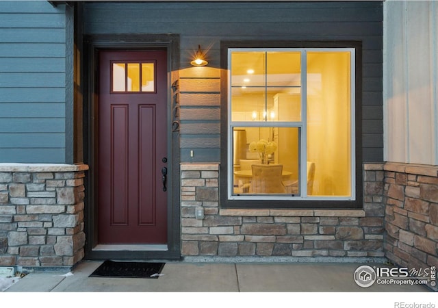 entrance to property with stone siding