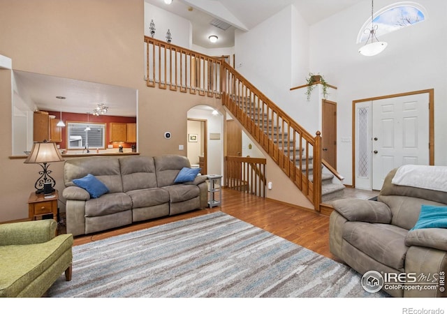 living room featuring light hardwood / wood-style flooring and a high ceiling