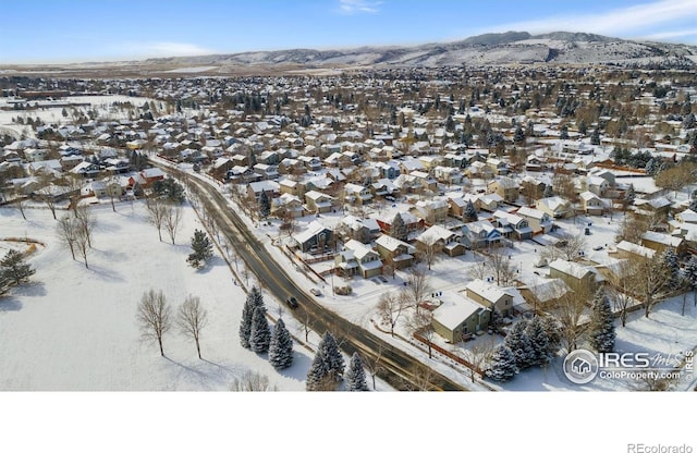 snowy aerial view featuring a mountain view