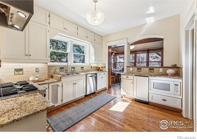 851 14th St, Boulder, CO 80302 - kitchen with stainless steel dishwasher, white microwave, extractor fan, tasteful backsplash, and a sink