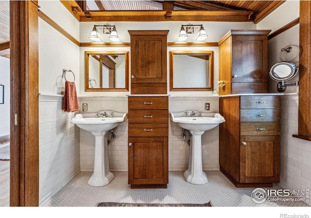 851 14th St, Boulder, CO 80302 - bathroom featuring tile walls, a sink, a wainscoted wall, wooden ceiling, and beamed ceiling