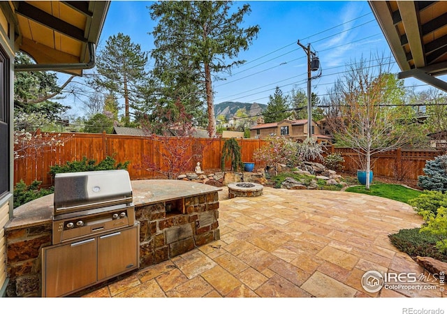 851 14th St, Boulder, CO 80302 - view of patio featuring a fenced backyard, grilling area, an outdoor fire pit, and area for grilling
