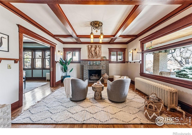 851 14th St, Boulder, CO 80302 - living room featuring a brick fireplace, wood finished floors, baseboards, radiator heating unit, and coffered ceiling