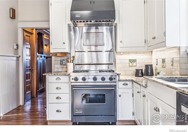 851 14th St, Boulder, CO 80302 - kitchen with white cabinets, light stone counters, dark wood finished floors, exhaust hood, and premium stove