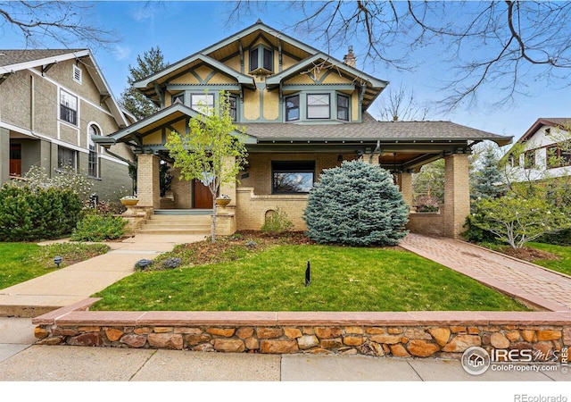 851 14th St, Boulder, CO 80302 - craftsman inspired home with a front lawn, covered porch, a chimney, brick siding, and a shingled roof
