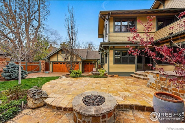 851 14th St, Boulder, CO 80302 - view of patio with an attached garage, fence, a fire pit, and a gate
