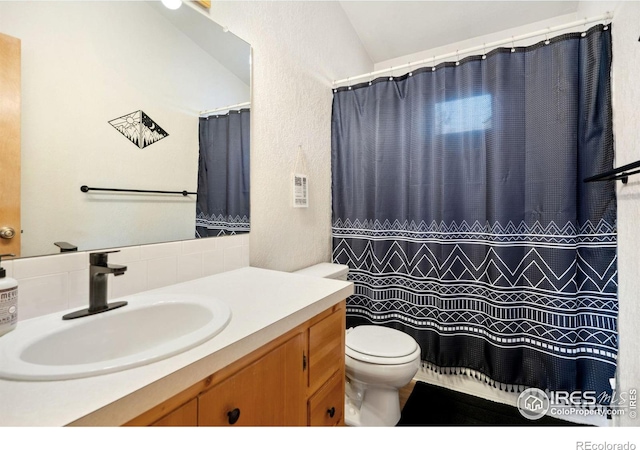 bathroom featuring toilet and vanity