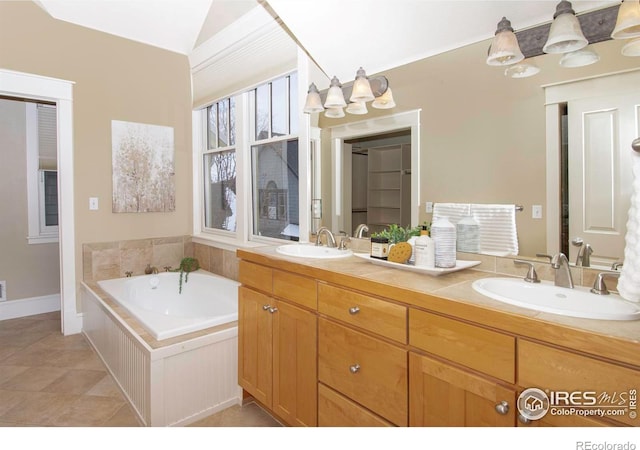 bathroom with lofted ceiling, tile patterned flooring, vanity, and a bathing tub