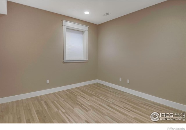 empty room with light hardwood / wood-style flooring