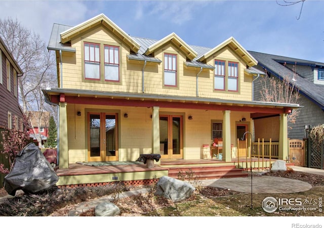 view of front of property with covered porch and french doors