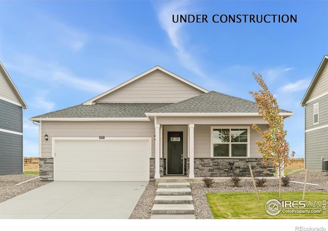 view of front facade featuring an attached garage, stone siding, a porch, and concrete driveway