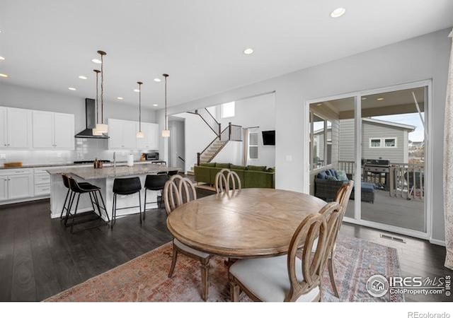 887 Sundance Ln, Erie, CO 80516 - dining area with dark wood-style flooring, stairs, and recessed lighting