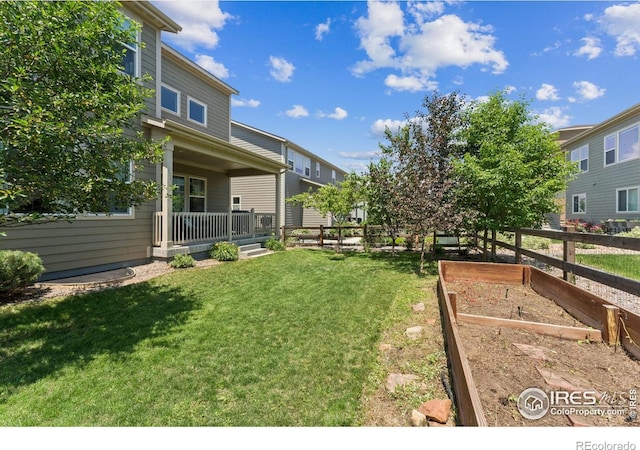 887 Sundance Ln, Erie, CO 80516 - view of yard with a vegetable garden and covered porch