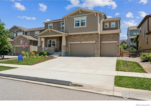 887 Sundance Ln, Erie, CO 80516 - craftsman inspired home with board and batten siding, a garage, driveway, and stone siding