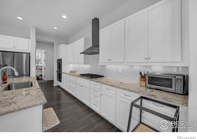 887 Sundance Ln, Erie, CO 80516 - kitchen featuring wall chimney range hood, stainless steel appliances, white cabinetry, dark wood-style floors, and recessed lighting