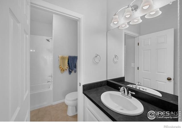 887 Sundance Ln, Erie, CO 80516 - bathroom featuring vanity, tile patterned flooring, and washtub / shower combination