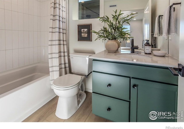 full bathroom featuring toilet, shower / bath combo, wood-type flooring, and vanity