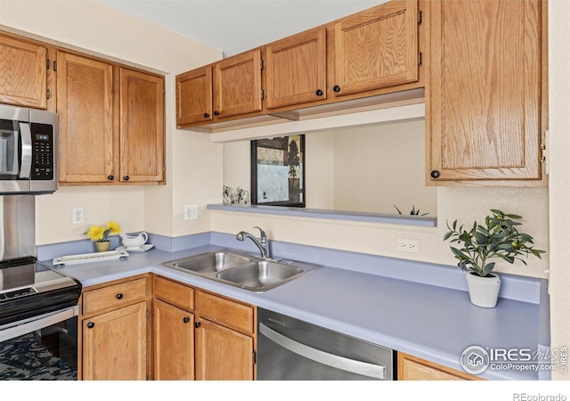 kitchen featuring a sink, light countertops, and stainless steel appliances