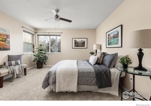 carpeted bedroom with a ceiling fan and baseboards