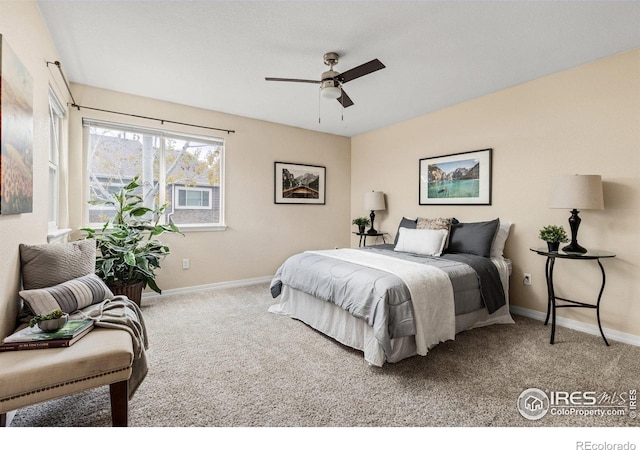 carpeted bedroom with baseboards and ceiling fan