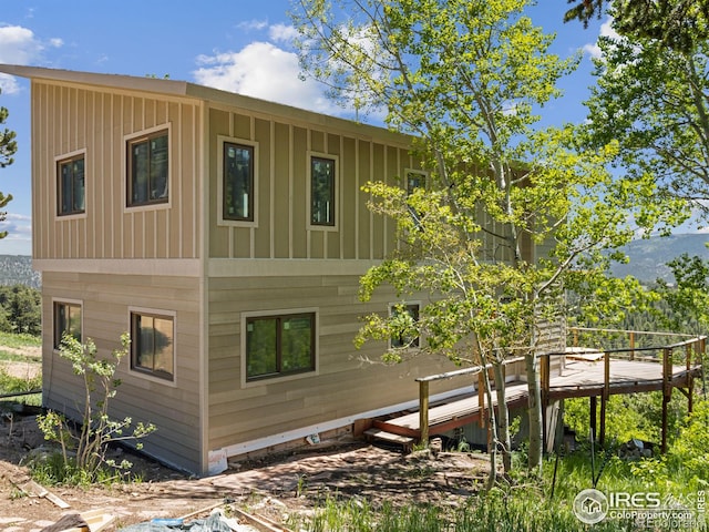 view of property exterior with a deck