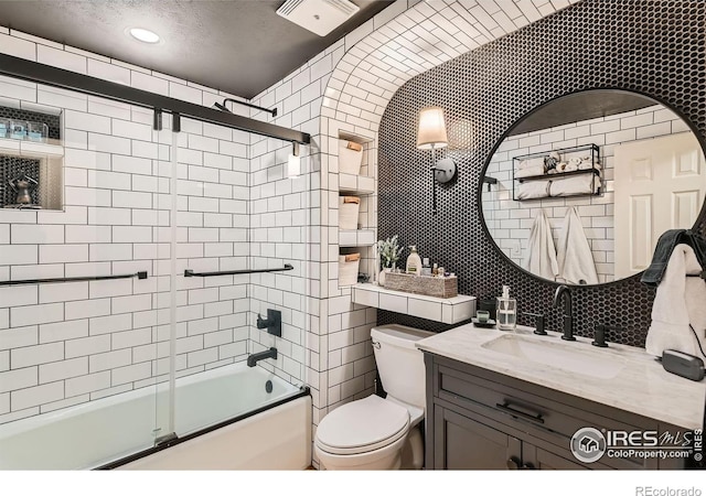 full bathroom featuring toilet, tile walls, decorative backsplash, enclosed tub / shower combo, and vanity