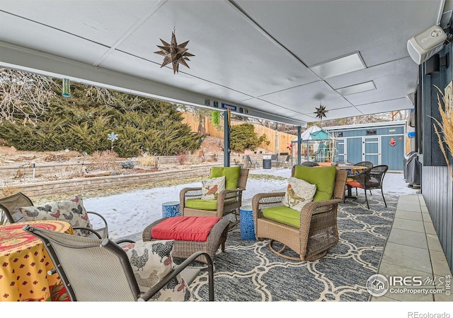 view of patio featuring outdoor lounge area and a storage shed