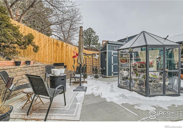 view of patio / terrace featuring a storage shed