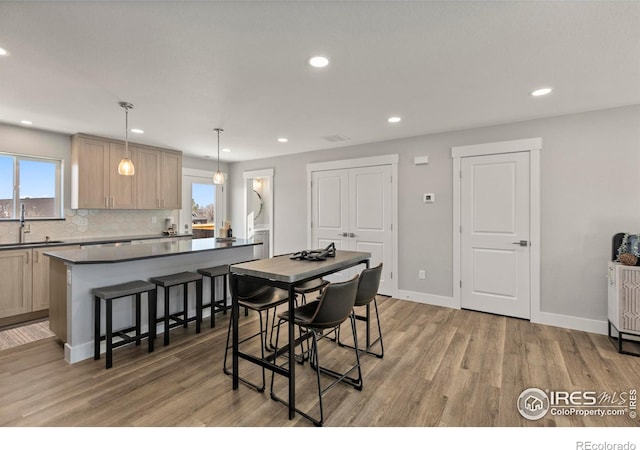 dining area with recessed lighting, wood finished floors, and baseboards