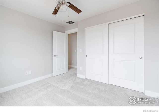 unfurnished bedroom with light carpet, baseboards, visible vents, a ceiling fan, and a closet