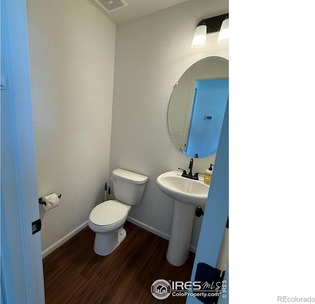 3510 Valleywood Ct, Johnstown, CO 80534 - bathroom featuring wood finished floors, toilet, and baseboards
