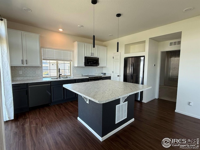 3510 Valleywood Ct, Johnstown, CO 80534 - kitchen featuring black appliances, a sink, light countertops, dark wood finished floors, and backsplash