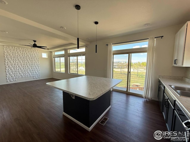 3510 Valleywood Ct, Johnstown, CO 80534 - kitchen featuring a ceiling fan, baseboards, dark wood-style flooring, and light countertops