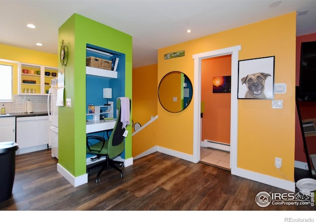 home office featuring dark hardwood / wood-style flooring and a baseboard heating unit