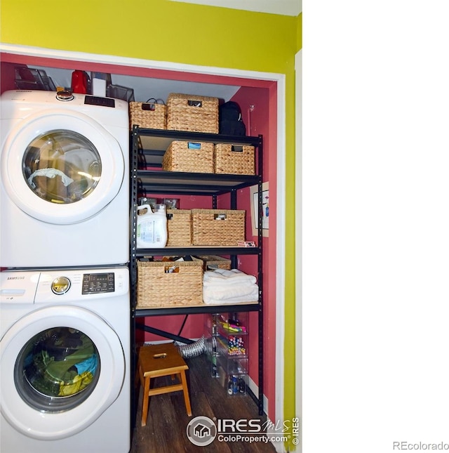 washroom featuring stacked washer / dryer and dark hardwood / wood-style flooring