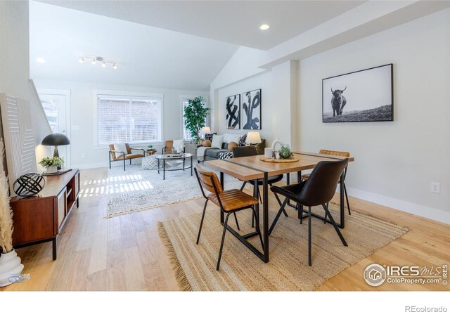 dining space with vaulted ceiling, recessed lighting, wood finished floors, and baseboards