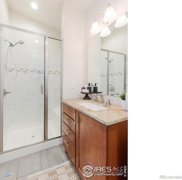 bathroom featuring a shower stall, vanity, and tile patterned floors