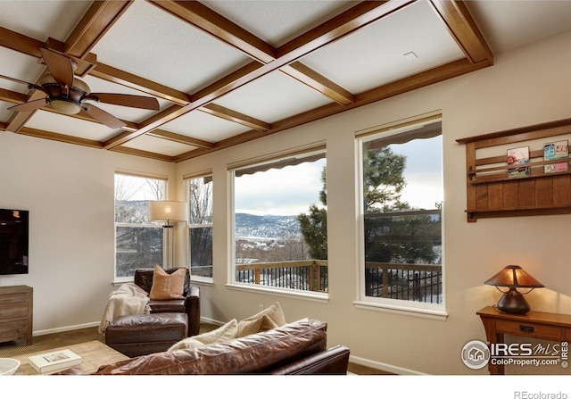 living room with baseboards, coffered ceiling, beamed ceiling, carpet flooring, and a mountain view