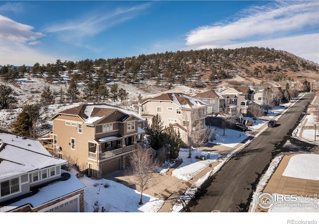 snowy aerial view featuring a residential view